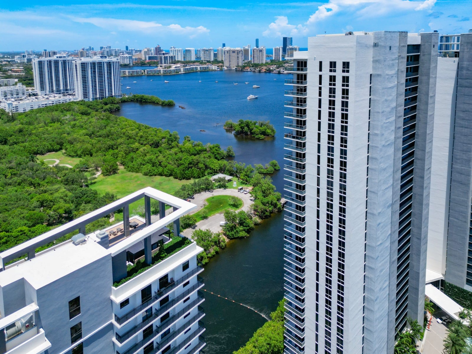 Aerial view of The Harbour towers beside the mangrove-lined bay