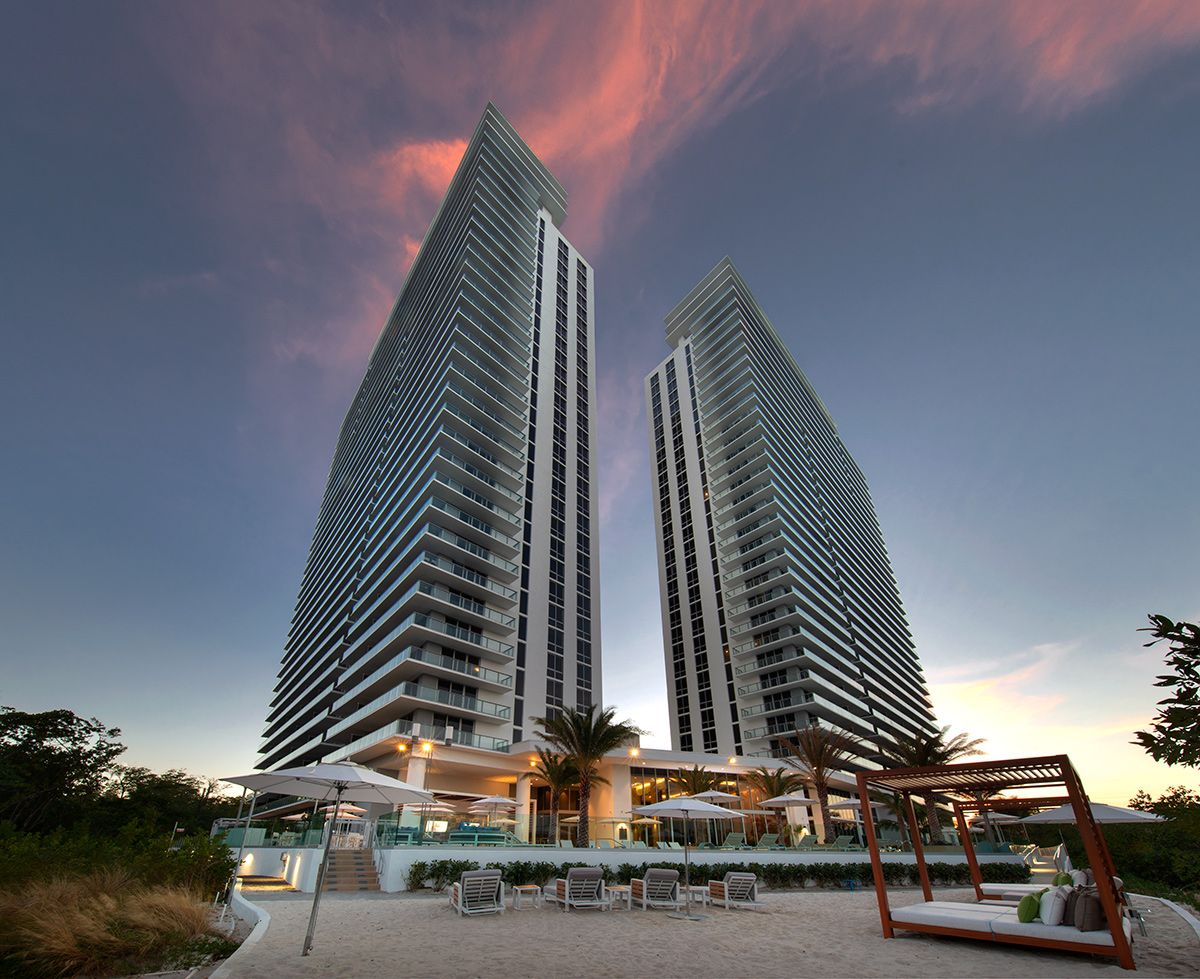 The Harbour's twin towers at dusk with private beach amenity deck