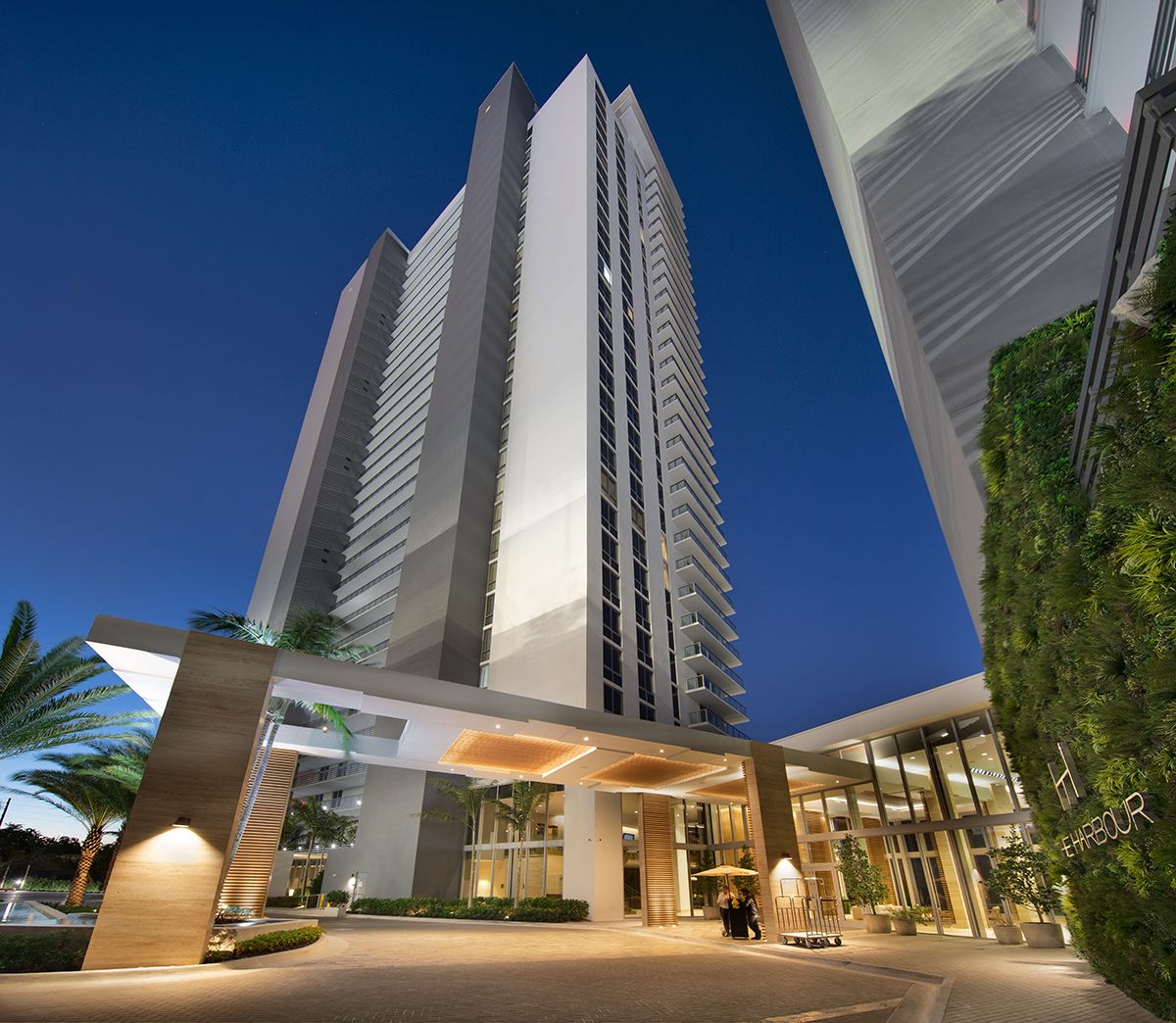 Porte-cochere entrance and valet arrival at The Harbour at dusk
